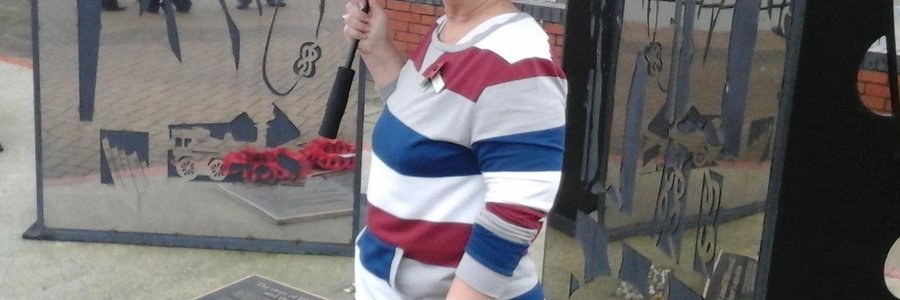 Glenda Kitley at the monument of the Birkenhead in the town, Birkenhead next to the wreathes laid by herself and the Mayor, Councilor Les Rowlands
